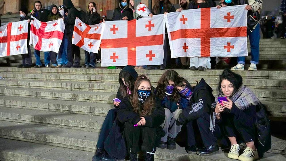 Demonstrators hold Georgian flags during a protest rally against the government's decision to suspend negotiations on accession to the European Union. Photo: Pavel Bednyakov/AP/dpa