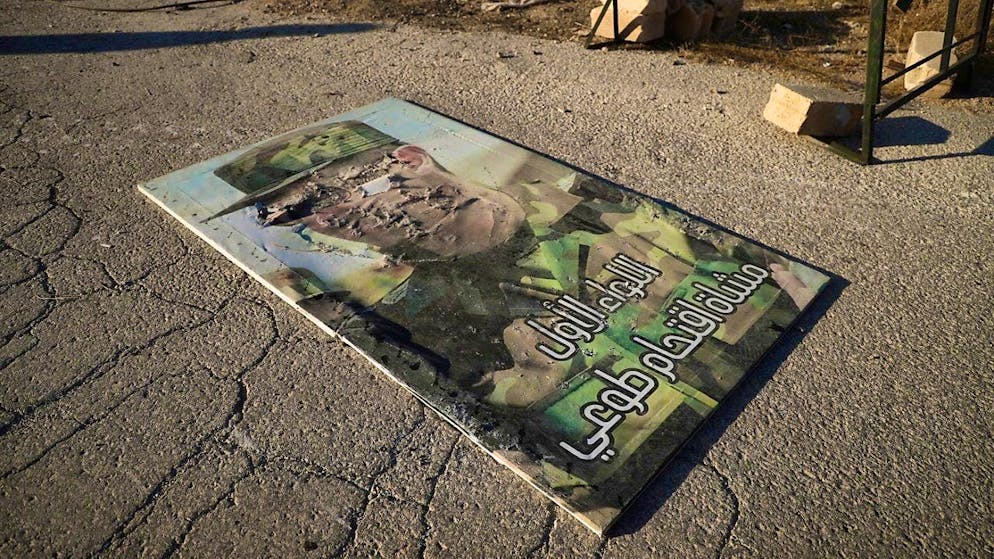 ARCHIVE - A destroyed poster with a photo of Syrian President Bashar al-Assad lies on the ground. Photo: Omar Albam/AP/dpa