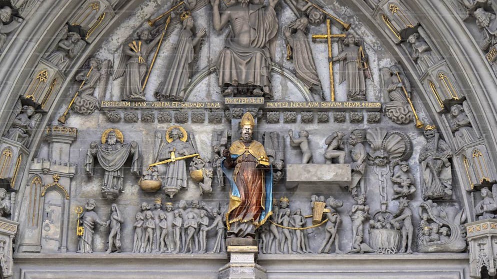 La statue de Saint Nicolas de Myre accueille croyants et visiteurs depuis le portail principal de la cathédrale de Fribourg, sans sa crosse. Ce bâton recourbé dans sa partie supérieure est l'insigne de l'autorité épiscopale.