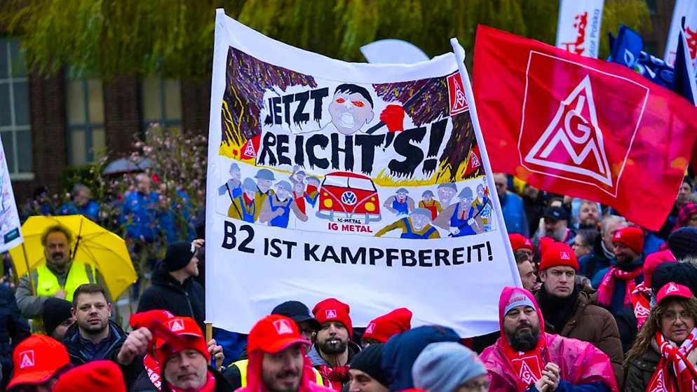VW employees take part in an IG Metall rally in front of the Volkswagen headquarters in Wolfsburg on December 9, 2024.