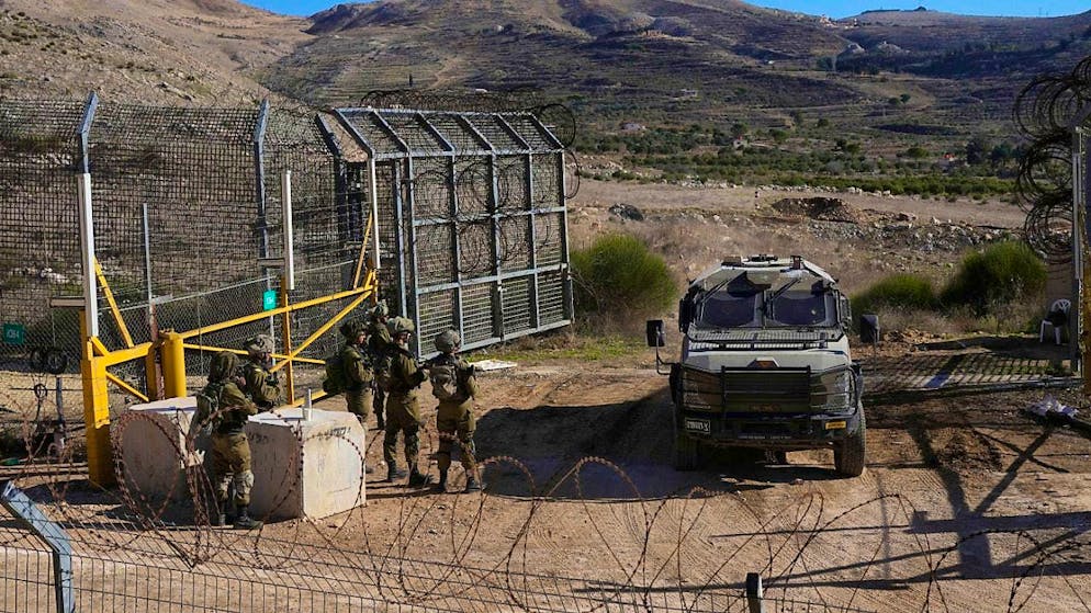 Israeli soldiers stand at a security fence near the so-called Alpha Line, which separates the Golan Heights annexed by Israel from Syria. Photo: Matias Delacroix/AP/dpa