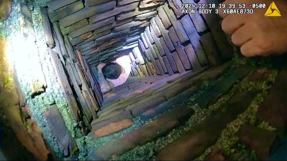 This image shows a police encounter with a man who hid in a chimney to evade arrest in Fall River, Massachusetts.