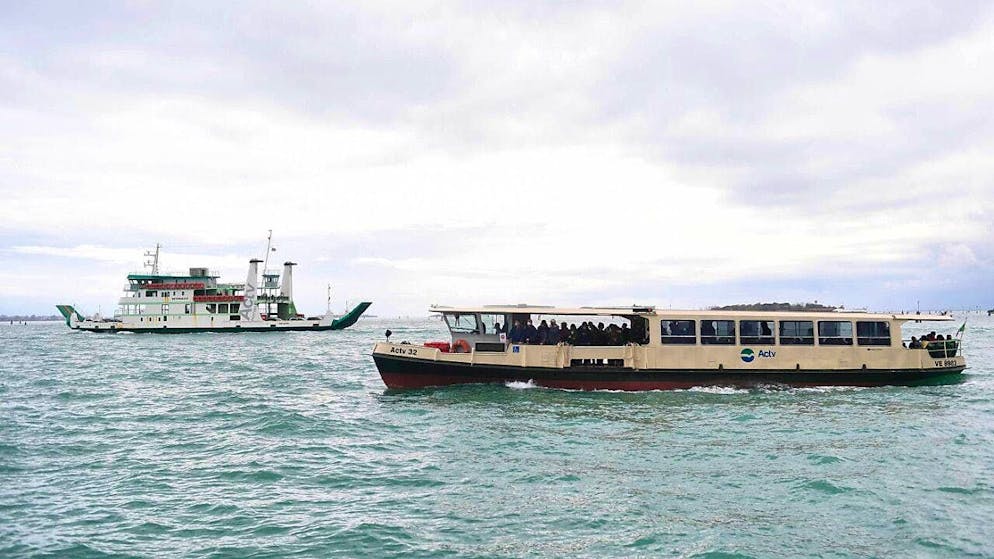 ARCHIVE - A boat and a vaporetto can be seen in the Venice lagoon. Photo: Felix Hörhager/dpa