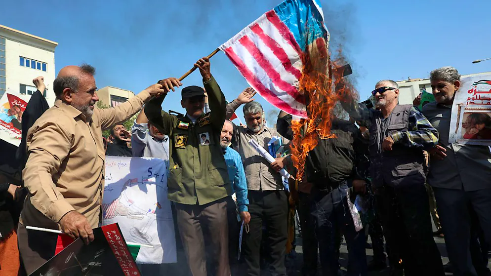 ARCHIV - Iranische Demonstranten verbrennen eine US-amerikanische Fahne in Teheran. Foto: Vahid Salemi/AP/dpa
