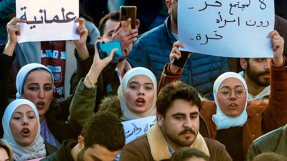 Syrian women chant slogans while holding placards with Arabic inscriptions: "No free society without free women" (r) and "Secularism", during a demonstration for a secular state at Umayyad Square in Damascus. Photo: Omar Sanadiki/AP/dpa