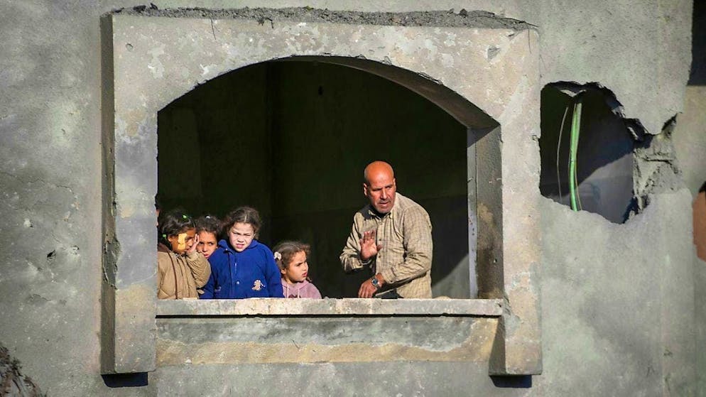 People watch the funeral procession for the victims of an Israeli attack on a house late on Saturday in Deir al-Balah, in the central Gaza Strip. Photo: Abdel Kareem Hana/AP/dpa