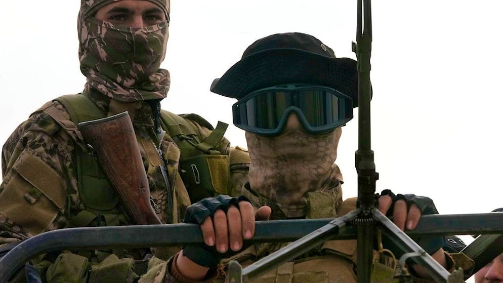 Syrian fighters stand on a vehicle while patrolling a highway. Photo: Hussein Malla/AP/dpa