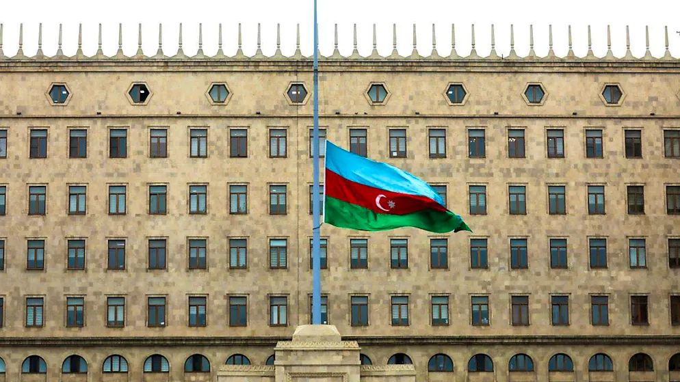The Azerbaijani national flag flies at half-mast in front of a government building to commemorate the victims of the Azerbaijan Airlines Embraer 190 that crashed near Aktau airport in Kazakhstan. Photo: Aziz Karimov/AP/dpa