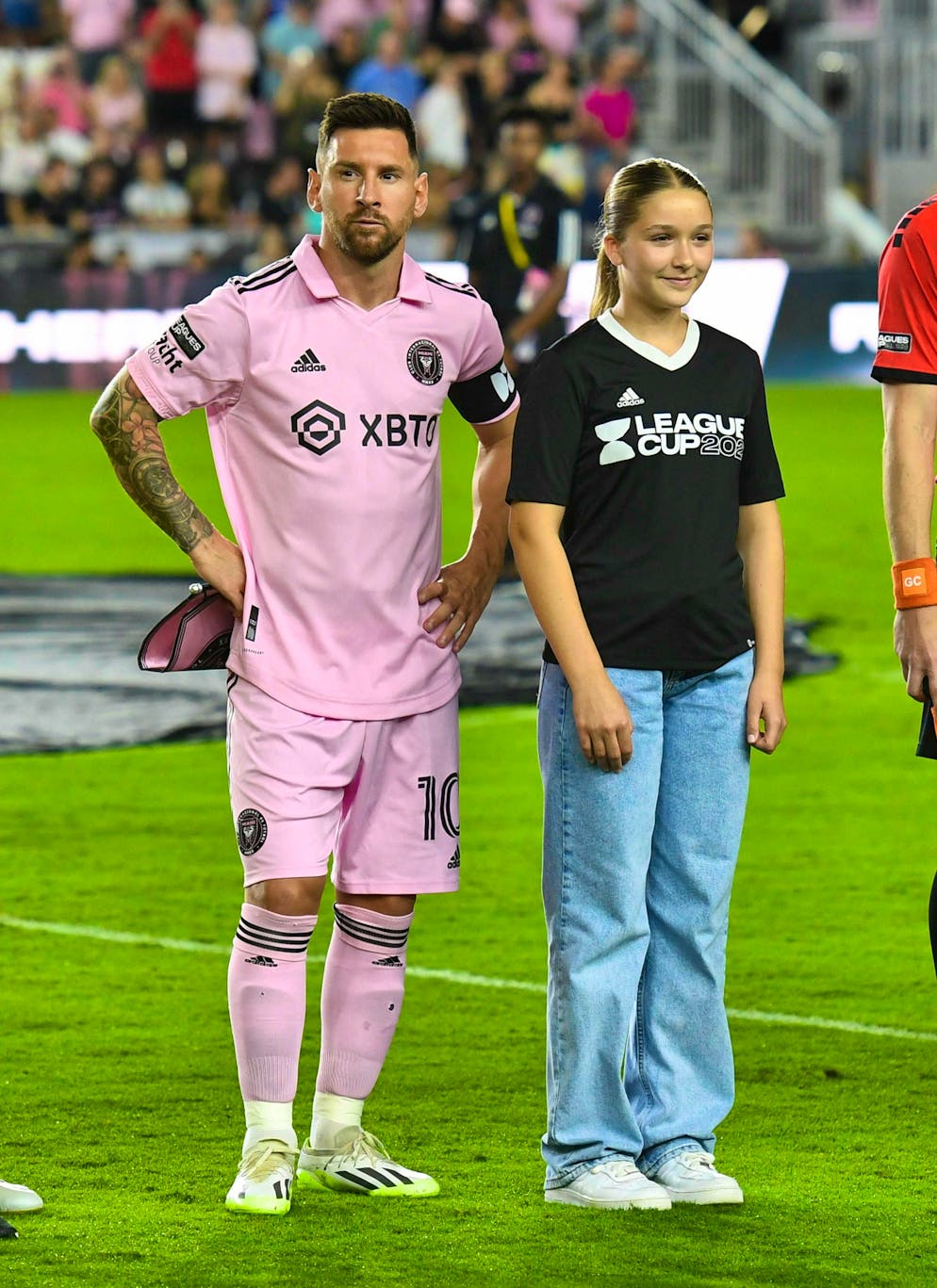 She also seems to be interested in football: Harper Beckham stood on the pitch with Lionel Messi in 2023.