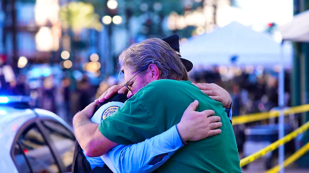 Edward Bruski (r) hugs New Orleans police officer Zachary Stevenson at the scene where a vehicle was driven into a crowd at Canal and Bourbon Streets in New Orleans. Photo: Gerald Herbert/AP/dpa