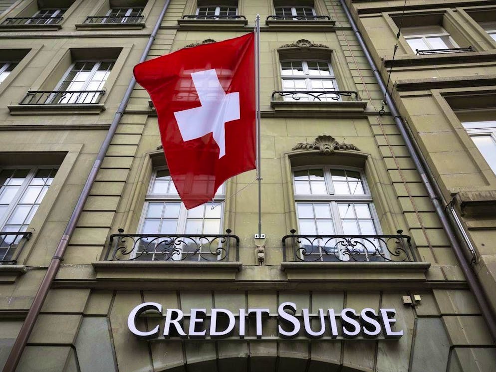 A Swiss flag flies over the Credit Suisse logo at the Credit Suisse branch in Bern, Switzerland, on Monday, May 8, 2023. (KEYSTONE/