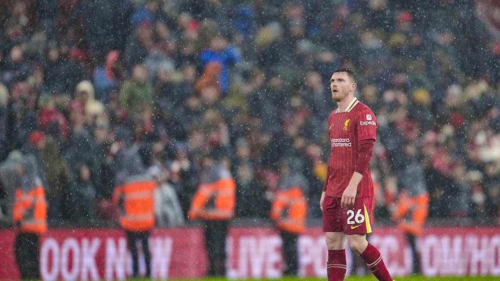 Full-back Andrew Robertson looks on in disappointment as Liverpool play in the rain