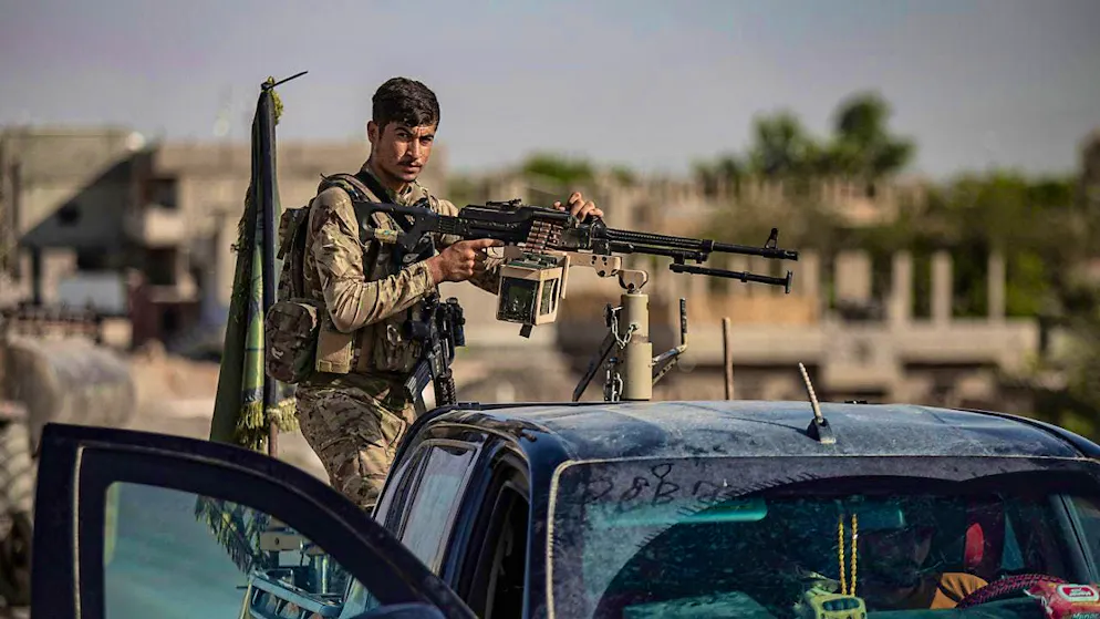 ARCHIVE - A US-backed Syrian Democratic Forces (SDF) fighter stands on an armored vehicle in eastern Syria. Photo: Baderkhan Ahmad/AP/dpa