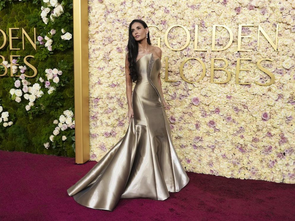 Demi Moore a fait sensation dans une robe sirène dorée et à bustier sculptural, signée Armani Privé.