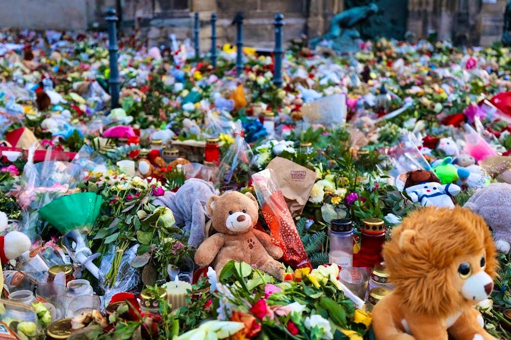 Hundreds of candles, flowers and stuffed animals in front of Magdeburg's St. John's Church on January 3.