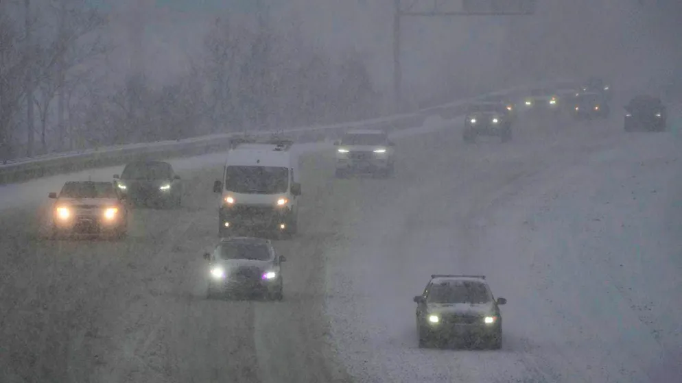 Vehicles drive across a highway during a winter storm. Photo: Joshua A. Bickel/AP/dpa