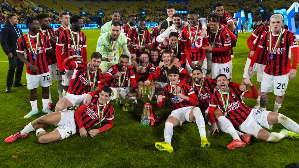 The Milan players celebrate victory in the Super Cup.