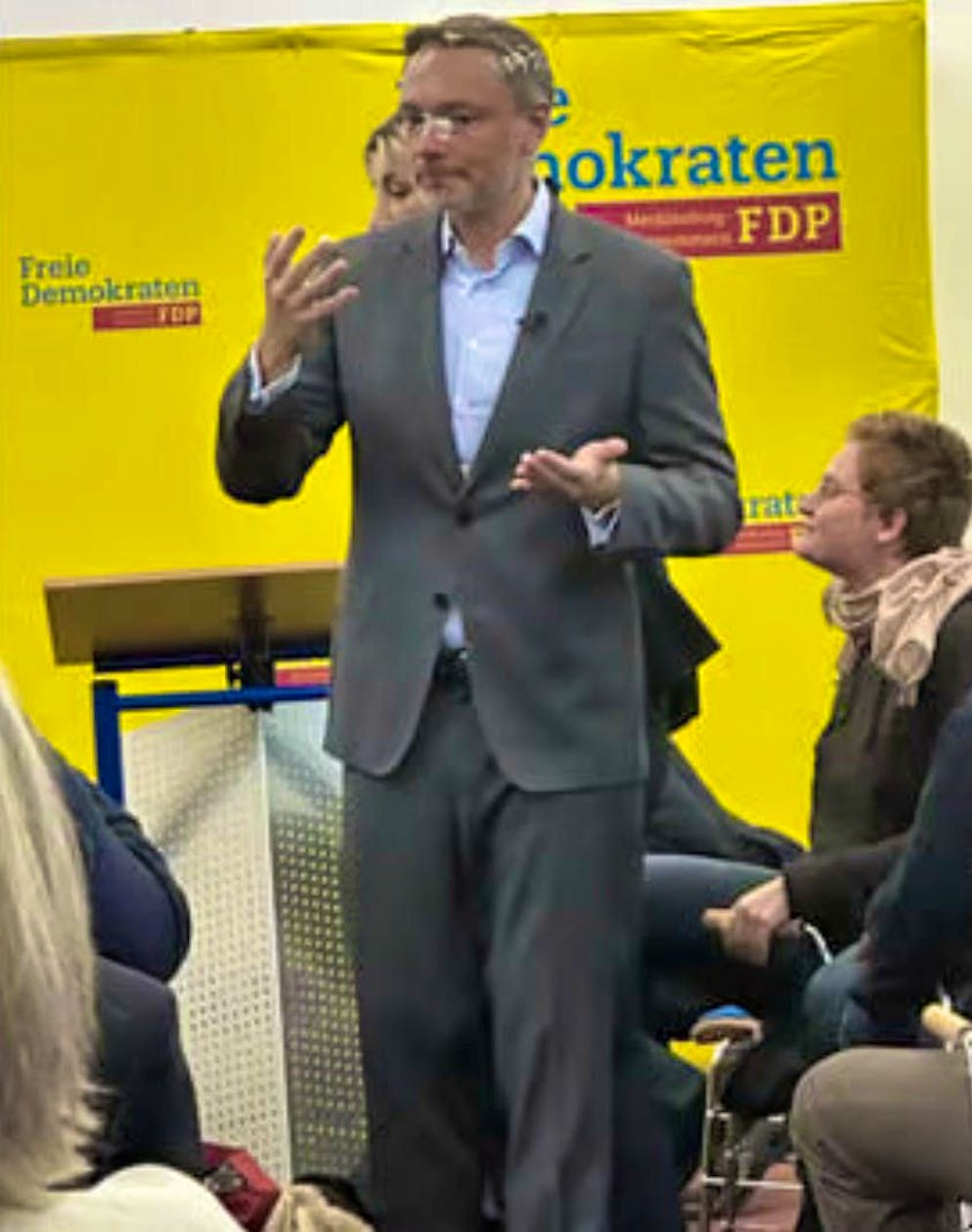 A cake is thrown at Christian Lindner during his election campaign speech. He remains cool and finishes the speech.