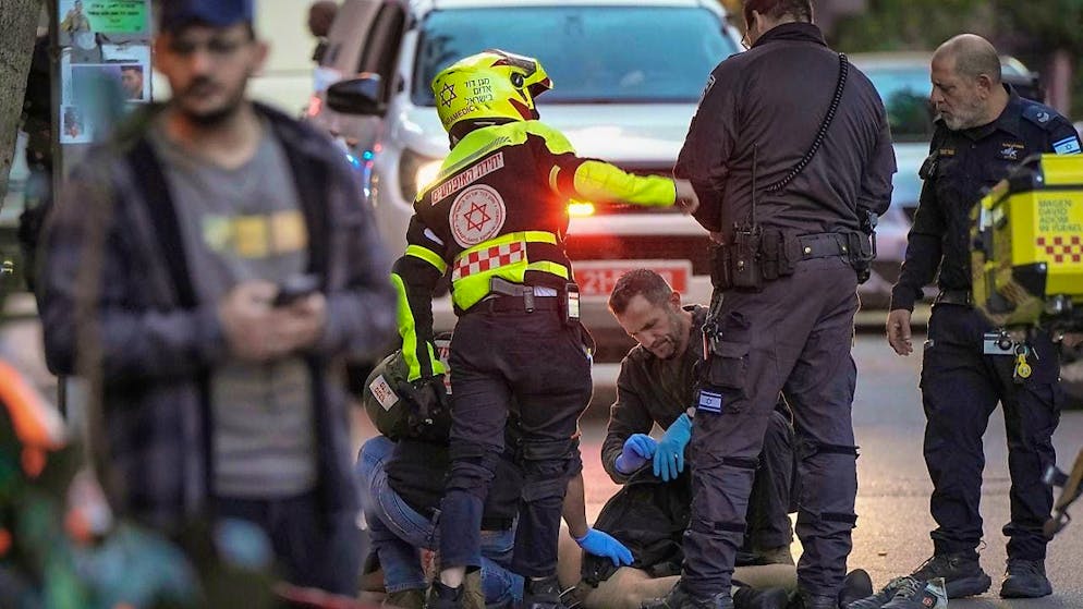 The body of a man who attacked and injured several pedestrians with a knife is examined by Israeli police after he was shot during the knife attack. Photo: Oded Balilty/AP/dpa