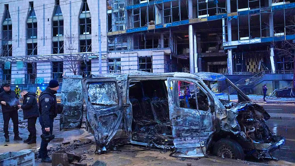 A destroyed car is seen while police officers work in front of a damaged building after a Russian missile attack. Photo: Efrem Lukatsky/AP/dpa