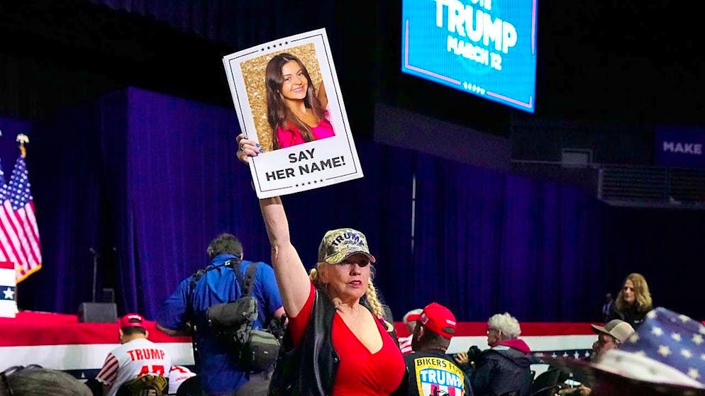 ARCHIVE - A supporter holds a poster with a photo of Laken Riley before Republican presidential candidate and former President Donald Trump speaks at a campaign rally in Rome Ga. Photo: Mike Stewart/AP/dpa