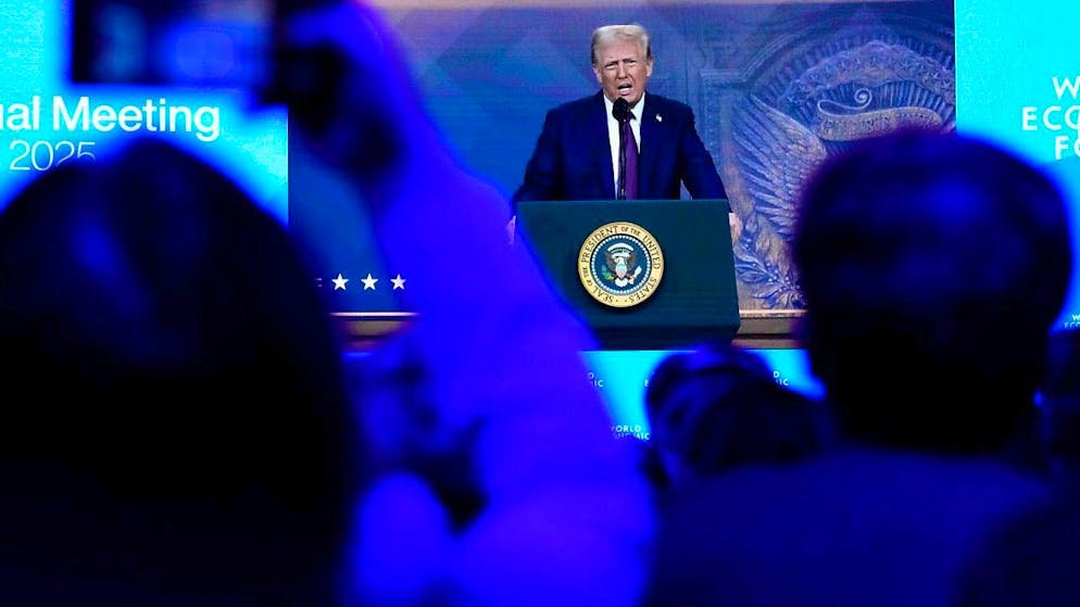 People watch a virtual speech by US President Donald Trump at the annual meeting of the World Economic Forum in Davos. Photo: Markus Schreiber/AP/dpa