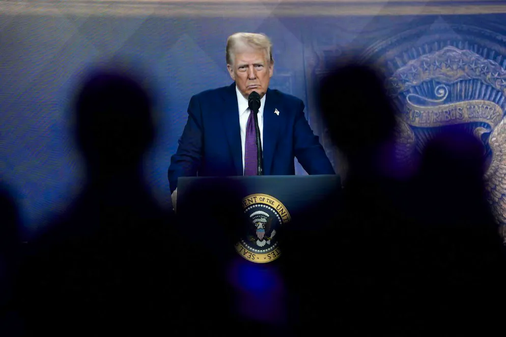 Attendees listen to a virtual speech delivered by U.S. president Donald Trump, at the Annual Meeting of World Economic Forum in Davos, Switzerland, Thursday, Jan. 23, 2025. (AP Photo/Markus Schreiber)