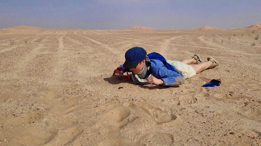 Anna Zappatini, an employee of the Natural History Museum Bern (NMBE), examines the meteorite at the site where it was found.