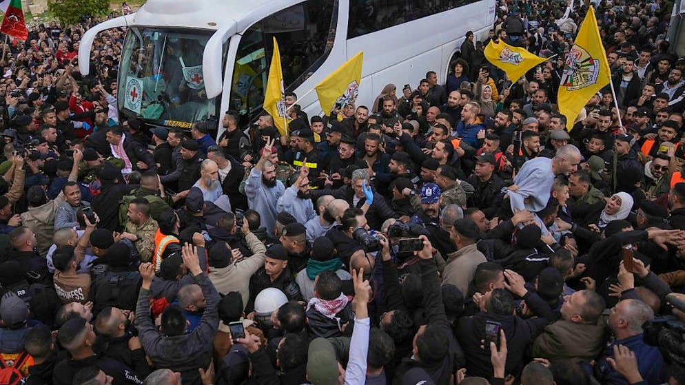 Palästinensische Gefangene werden von einer Menschenmenge begrüßt, nachdem sie nach der Waffenruhe mit Israel aus einem israelischen Gefängnis entlassen wurden. Foto: Mahmoud Illean/AP/dpa