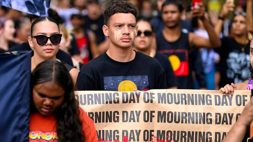"Day of Mourning" is written on a banner displayed by participants at a rally in Sydney on the controversial holiday "Australia Day", which opponents call "Invasion Day". Photo: Steven Markham/AAP/dpa
