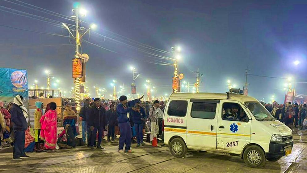 An ambulance leaves the scene of a stampede at the world's largest pilgrimage festival in India.