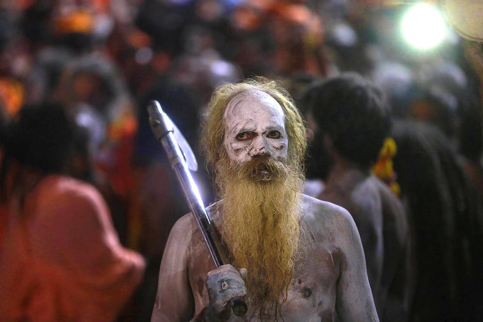 A Naga sadhu, or naked Hindu holy man arrives to take a holy dip in the Godavari River during Kumbh Mela, or Pitcher Festival, at Trimbakeshwar, near Nasik, India, Sunday, Sept. 13, 2015. Hindus believe taking a dip in the waters of a holy river during the festival, will cleanse them of their sins. According to Hindu mythology, the Kumbh Mela celebrates the victory of gods over demons in a furious battle over a nectar that would give them immortality. (AP Photo/Rafiq Maqbool)
