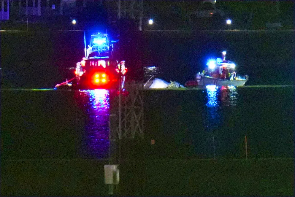 Rescue crews use boats to search for survivors in the freezing Potomac River next to Ronald Reagan Airport in Washington DC.