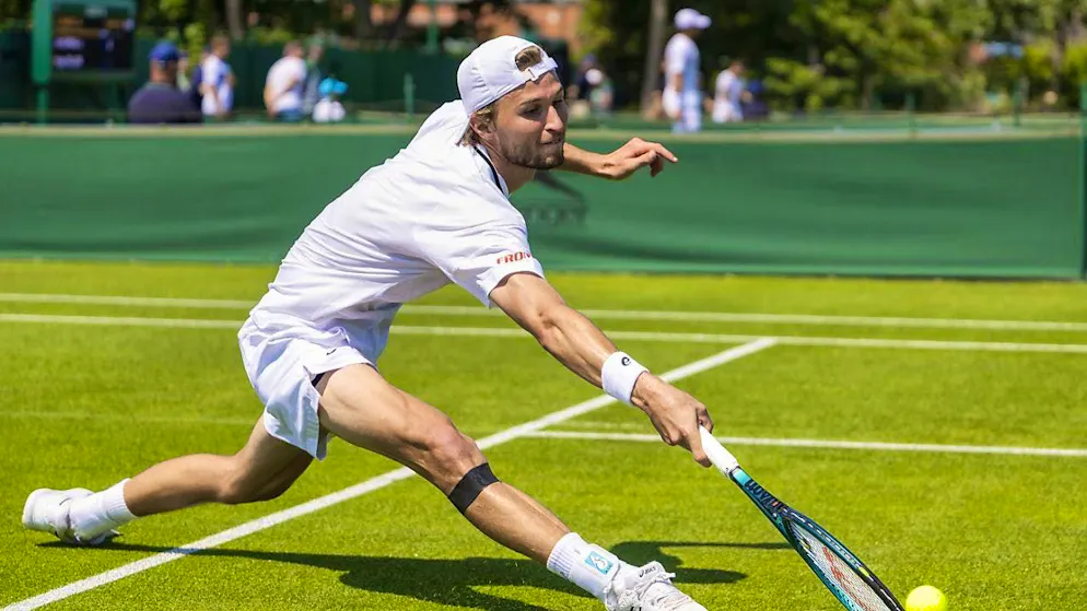 Leandro Riedi at Wimbledon last summer - with a taped right knee