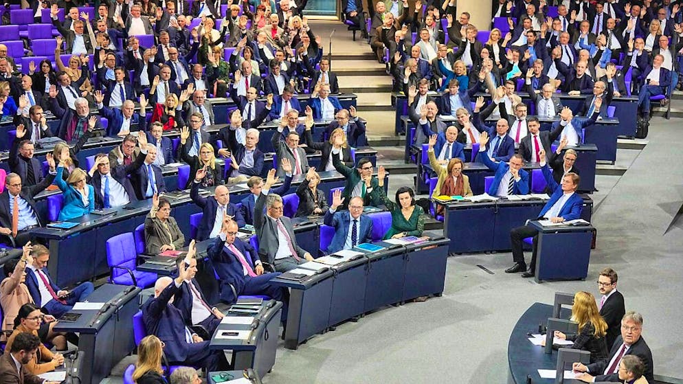 Members of the German Bundestag vote on the agenda to allow a vote on the CDU/CSU's "influx limitation law" to curb migration in the plenary chamber in the Bundestag.