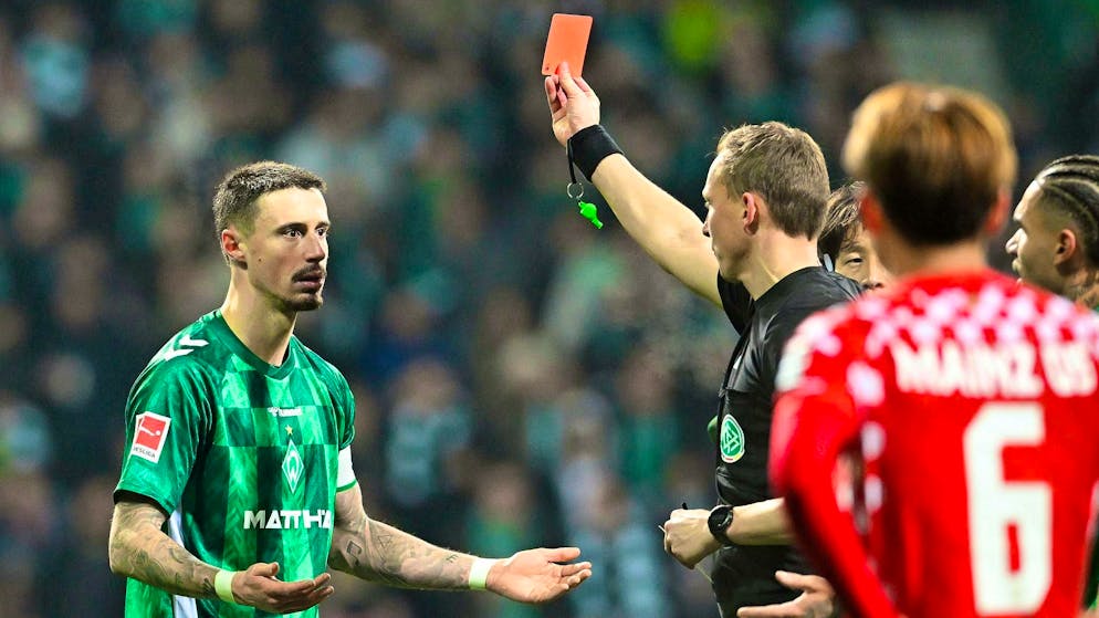Martin Petersen shows Werder's Marco Friedl yellow-red.