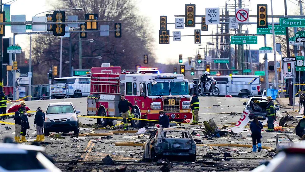 Firefighters work at the scene after the crash of a small plane. A private jet for a medical transport crashed in an area with many stores, houses and traffic. Photo: Matt Rourke/AP/dpa