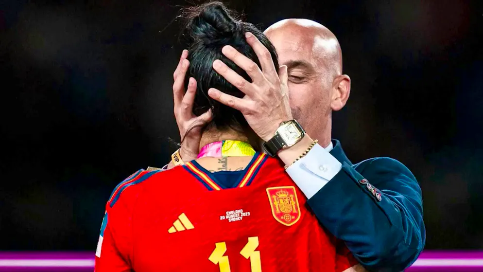 Trial over kissing scandal begins with victim testimony. Before the trophy presentation, Rubiales pulls world champion Hermoso close and gives her a kiss.