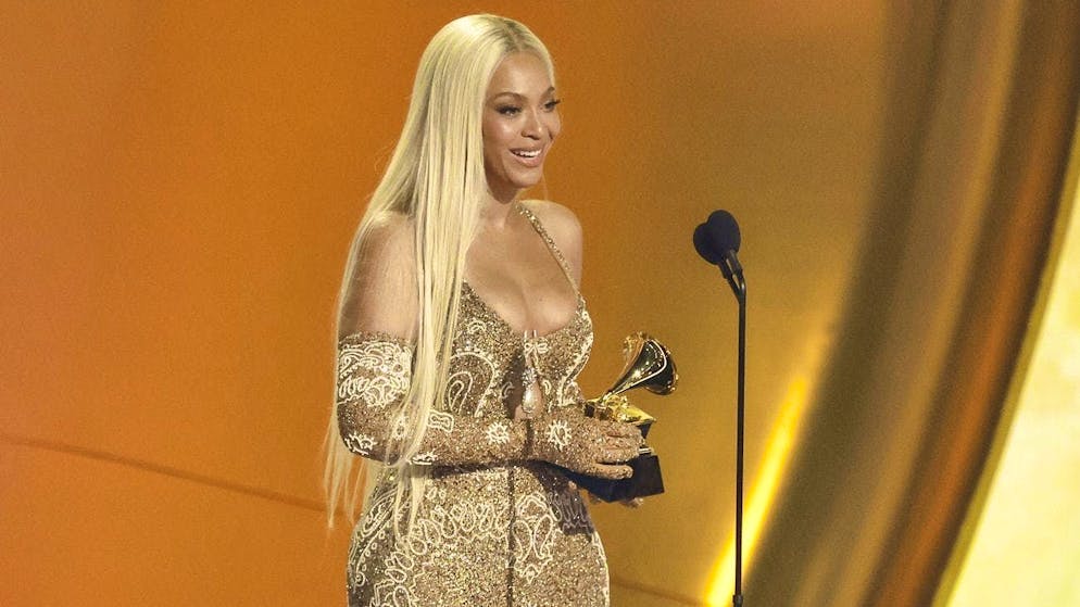Beyoncé accepts her first Grammy for "Album of the Year" on Sunday night in Los Angeles.