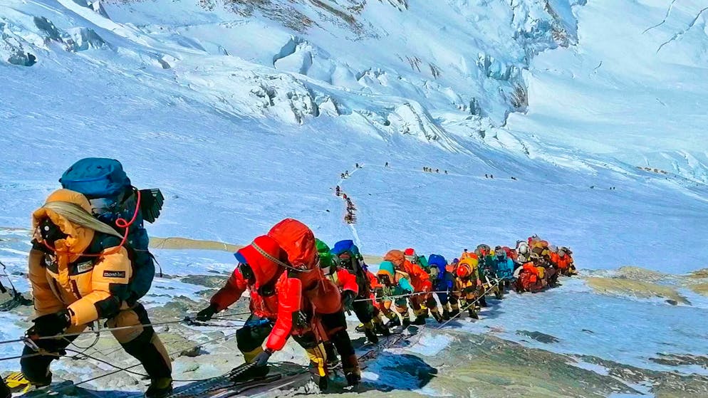Climbers walk in a long line on a path just below camp four on Mount Everst.