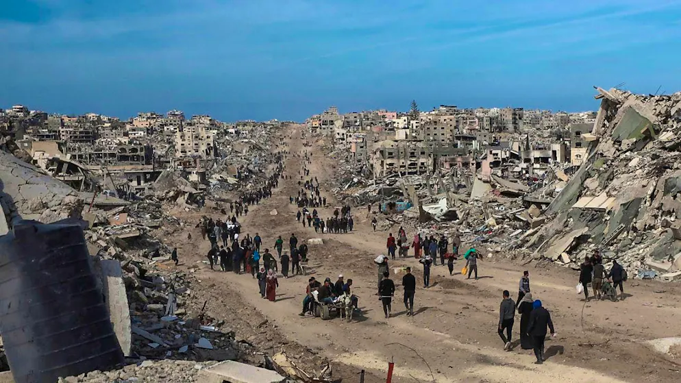 ARCHIVE - Palestinians walk through the destruction caused by the Israeli air and ground offensive in Jabaliya after a ceasefire agreement between Israel and Hamas came into effect. Photo: Abed Hajjar/AP/dpa