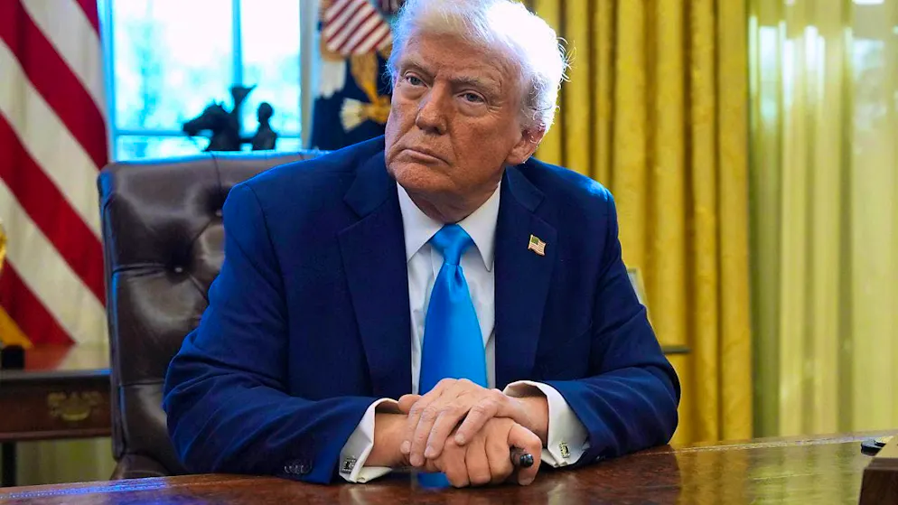 US President Donald Trump listens to a reporter's question in the Oval Office of the White House. Photo: Evan Vucci/AP/dpa