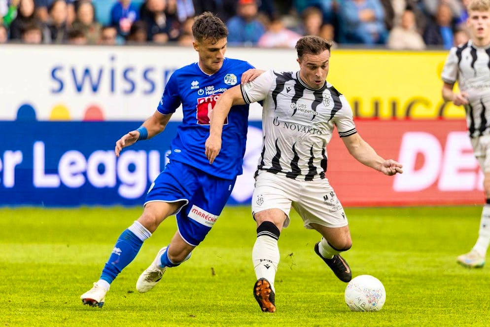 Aleksandar Stankovic (left) in a duel with Xherdan Shaqiri.