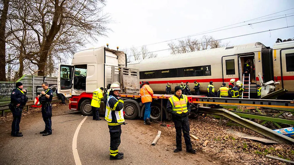 Emergency services stand at the scene of an accident at a level crossing. One person died and several were injured when an ICE train collided with a truck. Photo: Daniel Bockwoldt/dpa