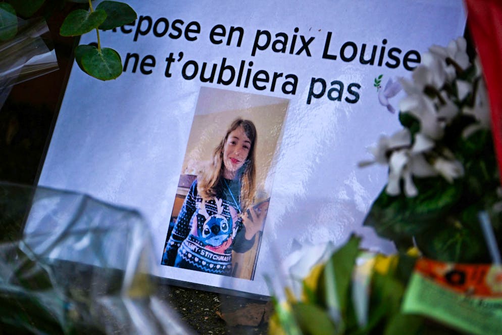 A photograph of Louise in front of her elementary school.