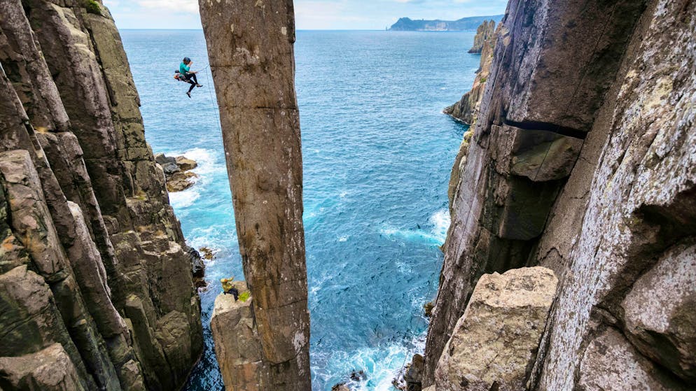 Climbers at Totem Pole, which juts straight out of the ocean.