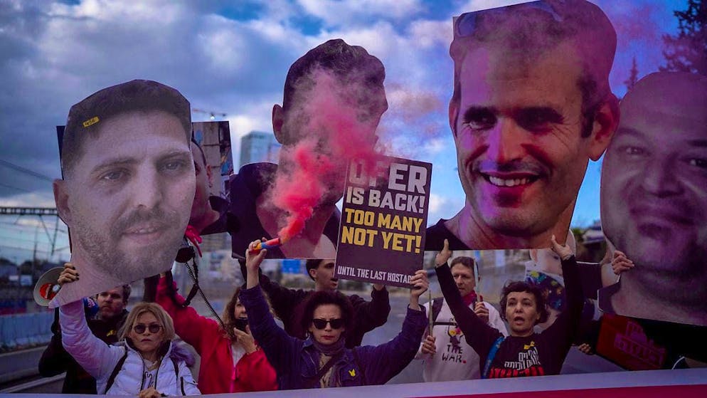 Relatives and supporters of Israelis held hostage in the Gaza Strip hold photos with their faces. Photo: Oded Balilty/AP/dpa