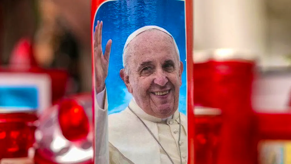 Candles, one of them with a photo of Pope Francis, stand in front of the Agostino Gemelli Polyclinic, where Pope Francis was hospitalized to undergo some necessary diagnostic tests and continue his ongoing treatment for bronchitis.