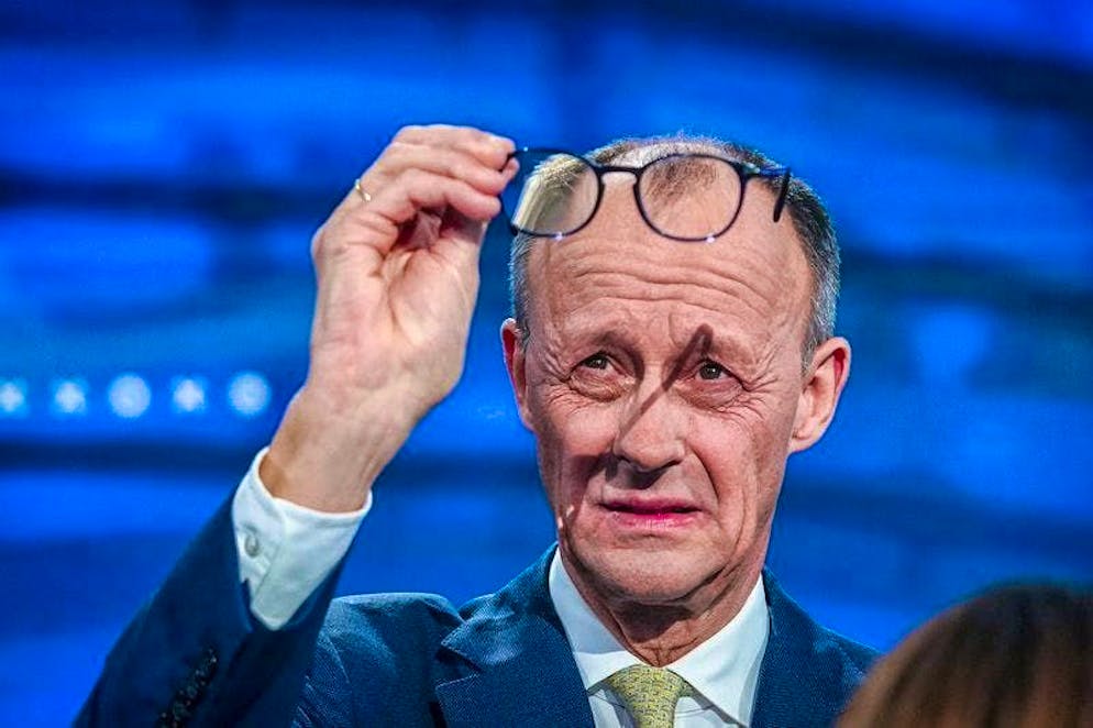 CDU candidate for chancellor and federal CDU chairman, Friedrich Merz, checks his glasses in the studio during the "Quadrell" TV discussion on the Bundestag election campaign. The live broadcast on RTL and NTV is hosted by Atalay and Jauch.