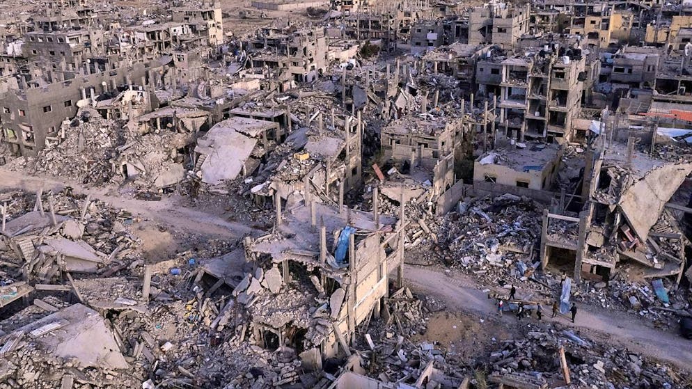 ARCHIVE - An aerial photo taken by a drone shows Palestinians in the ruins of the city of Rafah in the south of the Gaza Strip. It was reduced to rubble by Israeli attacks. Photo: Mohammad Abu Samra/AP/dpa